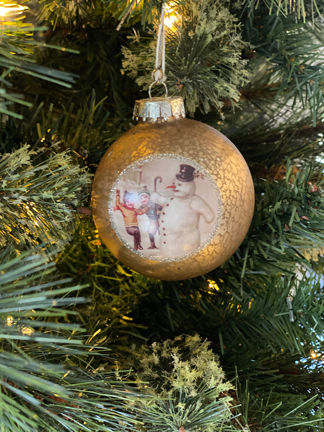 Kids Playing with Snowman Ornament